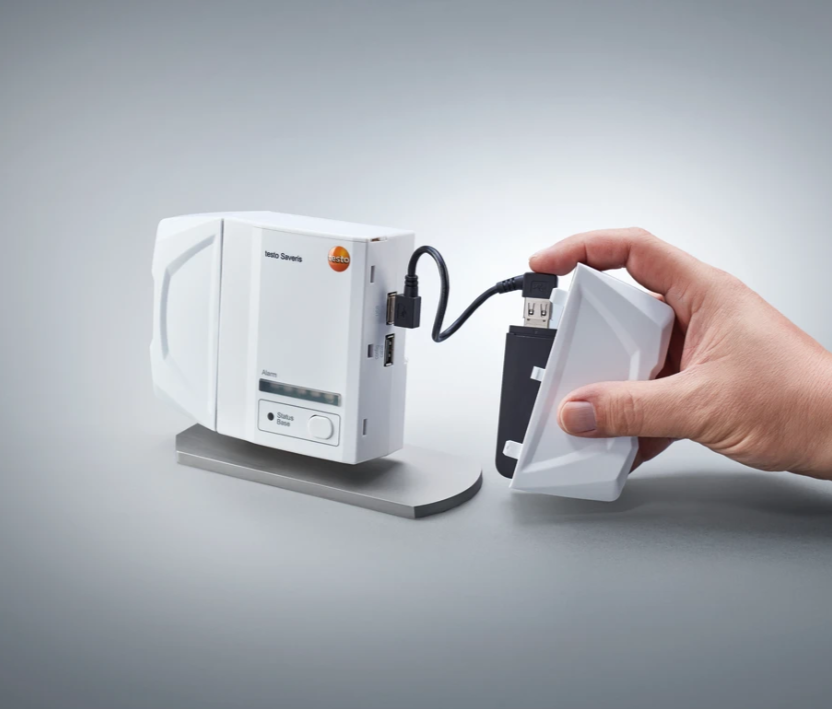 The testo Saveris Base V3.0 is the core component of the testo Saveris 1 environmental monitoring system. It manages measurement data from up to 3,000 channels, evaluates it and generates alarms if any limit value violations should occur.  The built-in emergency battery guarantees maximum data security, even in the event of a power failure. The system alerts you visually, as well as via e-mail and SMS. Optionally, further optical and acoustic signalling devices can be connected via an alarm relay.  Besides Ethernet and WLAN, the testo Saveris 1 environmental monitoring system also supports testo UltraRange long-range radio technology. In addition to using an existing infrastructure, this also offers the option of using an autonomous radio network via encrypted, proprietary signals, which has an excellent range and signal stability for use in enclosed spaces.  Delivery Scope testo Saveris Base including rechargeable battery and configuration cable.  *Caution: communication modules and mains units are not included in delivery.